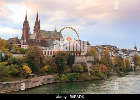 Basel Munster in the river Rhine, at the autumn fair with the ferris wheel in Switzerland