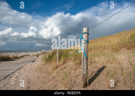 Decorative knotted rope or material to express the eternal commitment of loving couples. Sunny and windy day along the north sea beach during a long w Stock Photo