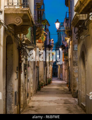 A picturesque road in Siracusa old town (Ortigia) at night. Sicily, southern Italy. Stock Photo