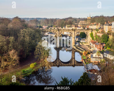 The railway viaduct reflected in the River Nidd on a sunny winter day at Knaresborough North Yorkshire England Stock Photo