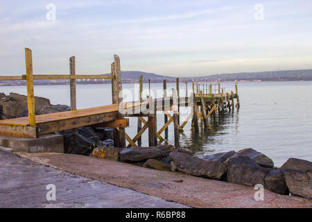 A small wooden pier used by the local yaucht club on The Esplanade at Holywood County Down. Belfast Lough and the distant County Antrim shore can be s Stock Photo