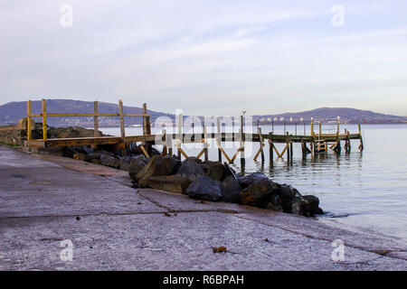 A small wooden pier used by the local yaucht club on The Esplanade at Holywood County Down. Belfast Lough and the distant County Antrim shore can be s Stock Photo
