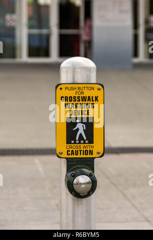 EVERETT, WA, USA - JUNE 2018: Sign and button push for operating a crosswalk warning device at the Boeing Visitor Center in Everett. Stock Photo