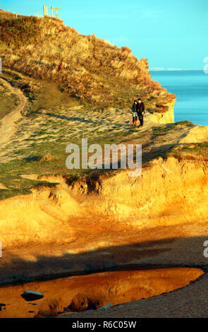 A couple walking on the cliffs at Seatown in Dorset Stock Photo