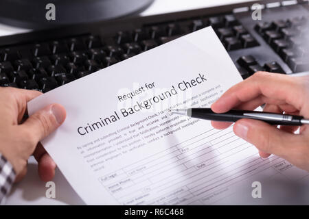 Person Hand Filling Criminal Background Check Application Form Stock Photo