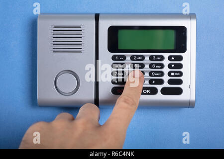 Person's Finger Entering Code In Security System Stock Photo