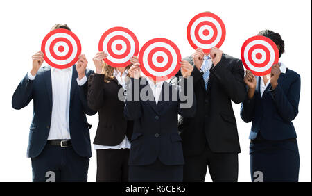 Businesspeople Hiding Face With Dartboard Stock Photo