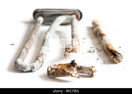 Damaged Heating Element of the Washing Machine on White Background. Stock Photo
