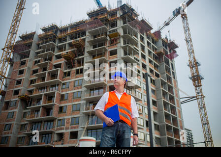 Architect on a construction site during a housing project Stock Photo