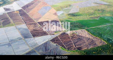 Green and brown agricultural fields above aerial  drone view Stock Photo