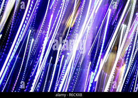 Abstract Blurred Background, Colourful speed and movement lights, Multi toned coloured lights, Mixed blue, purple, gold and green blurred lights Stock Photo