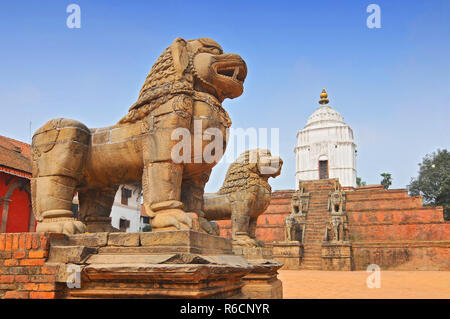 Stone Lions East Of Durbar Square With Fasidega Temple In Bhaktapur, Nepal Stock Photo