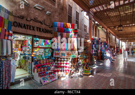 Bur Dubai Souk Shop And Sellers In The Ancient Covered Textile Souq Bur Dubai In The Old City Centre Of Dubai, United Arab Emirates Stock Photo