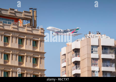 Emirates Airplane Airbus A380 Over Building In The Dubai Creek Al Hamriya District, Dubai, United Arab Emirates Stock Photo