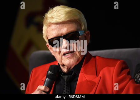 04 December 2018, North Rhine-Westphalia, Düsseldorf: The folk singer Heino sits on stage with a microphone at the event 'Jonges-Couch' of the home association 'Düsseldorfer Jonges' in the Henkel-Saal and was awarded the honorary membership of the association. Heino was born in Düsseldorf. Photo: Horst Ossinger//dpa Stock Photo