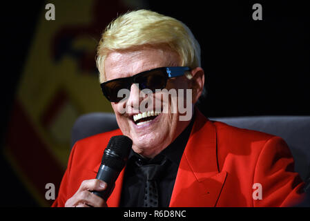 04 December 2018, North Rhine-Westphalia, Düsseldorf: The folk singer Heino sits on stage with a microphone at the event 'Jonges-Couch' of the home association 'Düsseldorfer Jonges' in the Henkel-Saal and was awarded the honorary membership of the association. Heino was born in Düsseldorf. Photo: Horst Ossinger//dpa Stock Photo