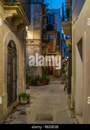 A picturesque road in Siracusa old town (Ortigia) at night. Sicily, southern Italy. Stock Photo