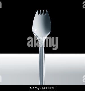 Cropped image of disposable plastic fork, white surface, black background Stock Photo