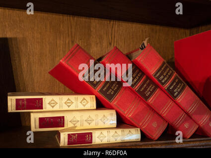 Old Red Leather bound books on a bookshelf Stock Photo