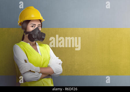 Attractive asian worker woman with crossed arms standing Stock Photo
