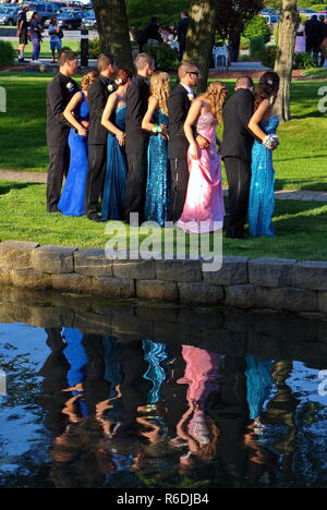 Plainville, CT USA. June 2013. A nice water reflection of the high school Class of 2013 in formal prom attire posing for the photographer. Stock Photo