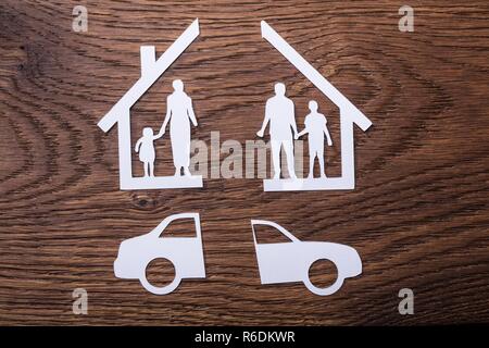 White Paper Cutout Of A Family Split Apart With Car Stock Photo