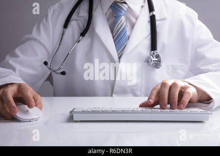 Doctor Using Computer Keyboard Stock Photo