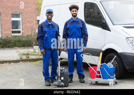 Portrait Of Two Happy Male Janitor Stock Photo