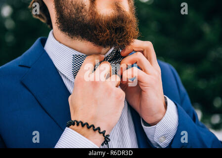 groom in a blue suit in the mountains Carpathians Stock Photo