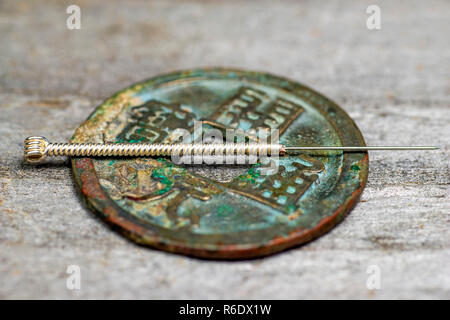 Acupuncture Needle On Antique Chinese Coin Stock Photo