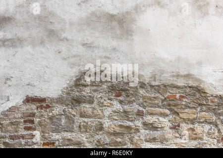Partially newly plastered brick wall Stock Photo