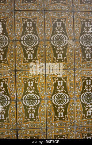 Lisbon / Portugal - May 2017: Portuguese traditional painted tin-glazed ceramic tiles Azulejos in orange and brown colors decorated with beautiful flo Stock Photo