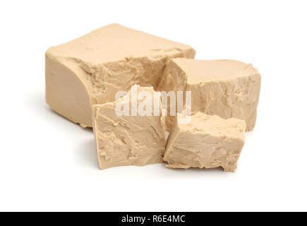 A block of compressed fresh yeast isolated. Stock Photo