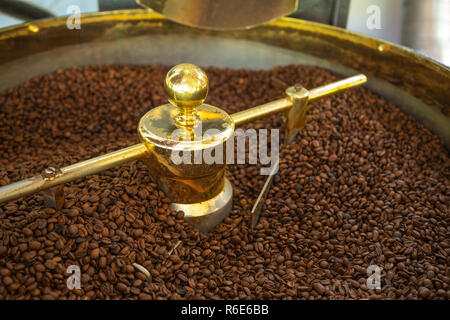 Closeup of organic coffee beans being roasted in a small roast house Stock Photo