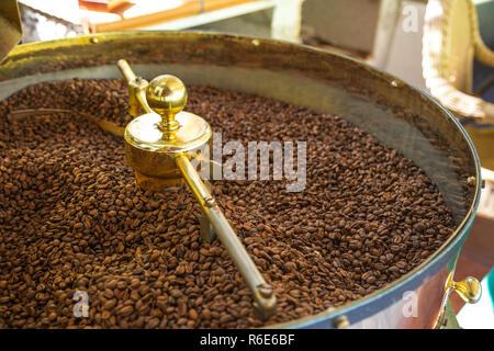 Closeup of organic coffee beans being roasted in a small roast house Stock Photo