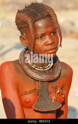 Young Himba Girl With The Typical Necklace And Double Plait Hairstyle, Omuramba, Kaokoland, Kunene, Namibia Stock Photo