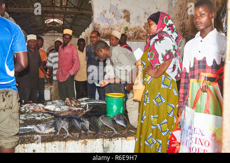 Darajani Market at Stone Town, people are buying the fish on public sale . Auction bidding of the food in the market Stock Photo