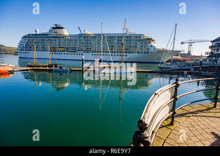 Luxury Cruise liner The World pulls into Falmouth docks in Cornwall for an overnight stop at one of Cornwalls most iconic destinations. Stock Photo