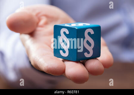 Person's Hand Holding Paragraph Block Stock Photo