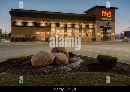 Utica, NY - DECEMBER 04, 2018: A Moe's Southwest Grill Restaurant Lit at Night. Moe's is A Fast Casual Dining Mexican Food Restaurant with over 680 Lo Stock Photo