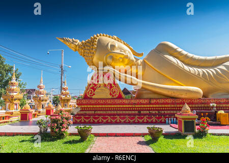 Giant Gold Reclining Sleeping Buddha Statue Near Wat That Luang Temple, Vientiane, Laos Stock Photo