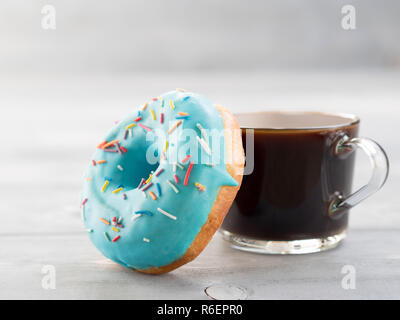 Blue donut and coffee on gray wooden background , copy space Stock Photo