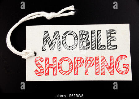 Handwritten text caption showing Mobile Shopping. Business concept writing for Cellphone online order written on price tag paper on the black vintage background. Stock Photo