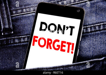 Writing text showing Do Not Forget. Business concept for Reminder Message written mobile cell phone with copy space in the back pants trousers pocket Stock Photo