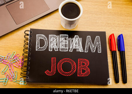 Handwriting Announcement text showing Dream Job. Business concept for Dreaming about Employment Job Position written on notebook book on the wooden background in the Office with laptop coffee Stock Photo