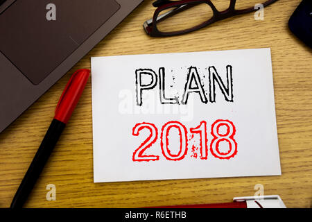 Handwriting Announcement text showing Plan 2018. Business concept for Planning Strategy Action Plan written on paper, wooden background in office with copy space, marker pen and glasses Stock Photo