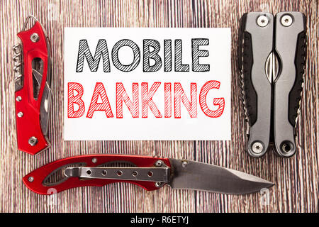 Conceptual hand writing text caption inspiration showing Mobile Banking. Business concept for Internet Banking e-bank Written on sticky note wooden background with pocket knife Stock Photo