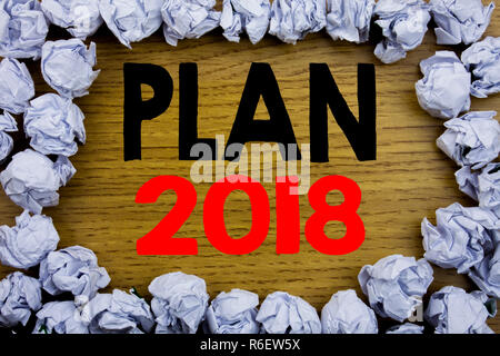 Handwriting Announcement text showing Plan 2018. Business concept for Planning Strategy Action Plan written on wooden wood background with space on old background with folded paper balls Stock Photo