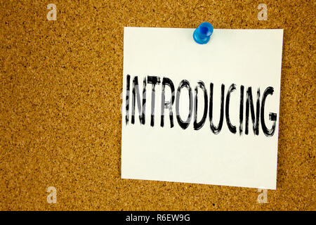 Conceptual hand writing text caption inspiration showing Introducing. Business concept for  Introduction Start Intro Beginning written on sticky note, reminder cork background with copy space Stock Photo