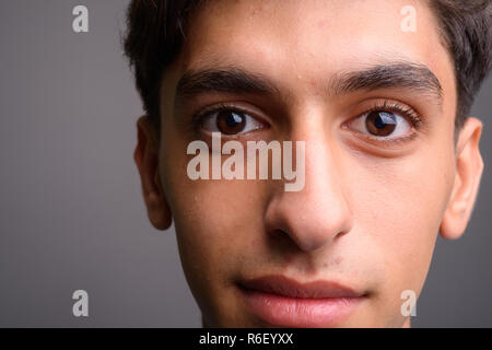 Close up of young handsome Persian teenage boy face Stock Photo
